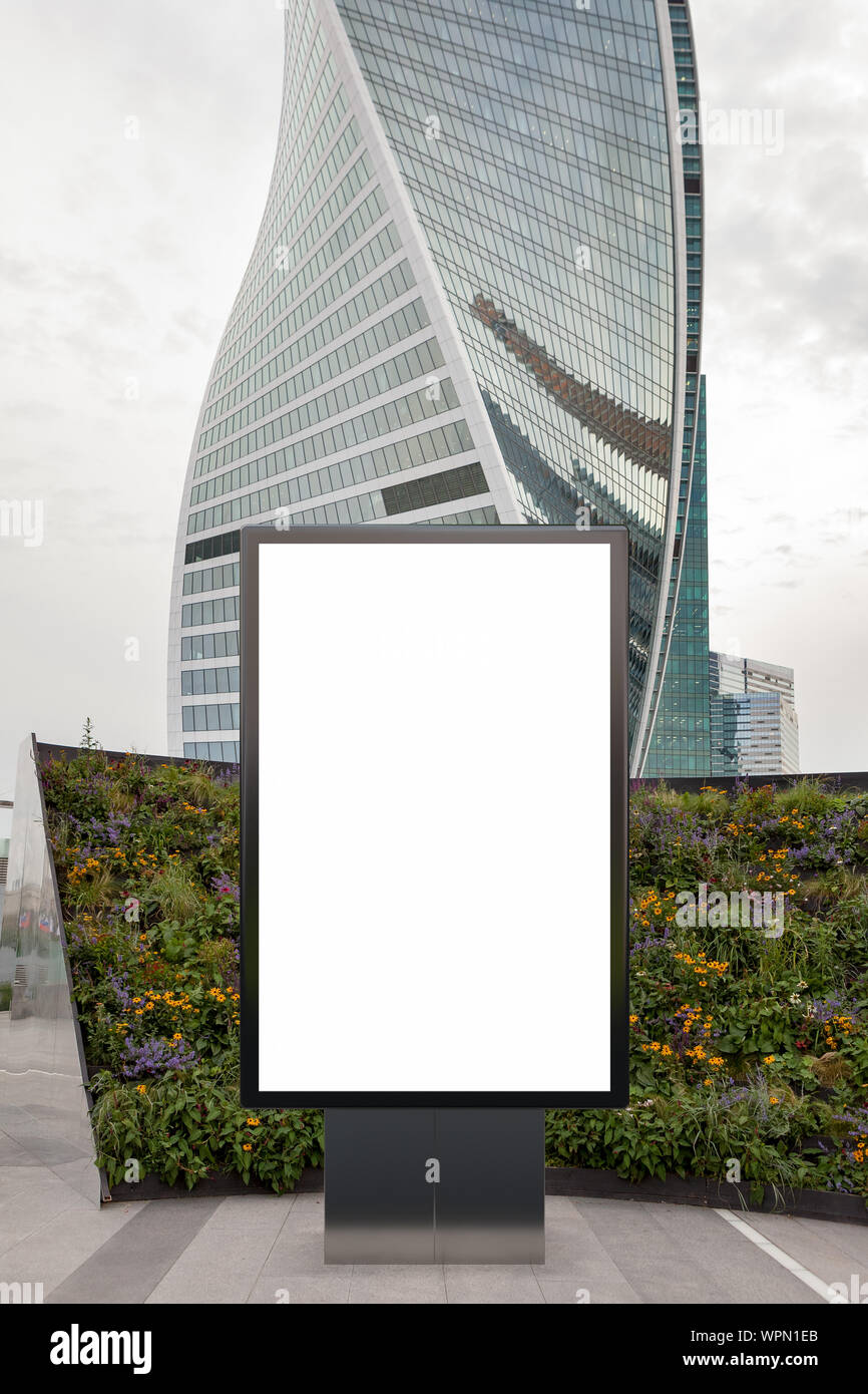 Blank street billboard poster stand mock up in downtown wth skyscraper ...
