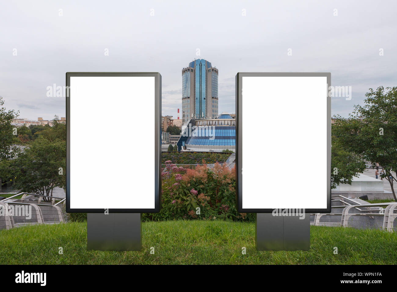 Two blank street billboard poster stands mock up in on the lawn in the ...