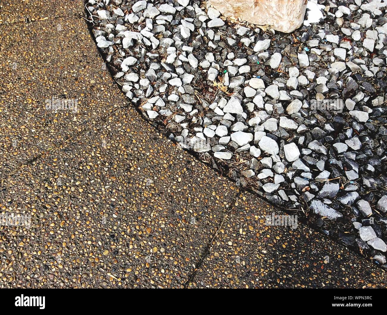 High Angle View Of Pebbles By Retailing Wall Stock Photo