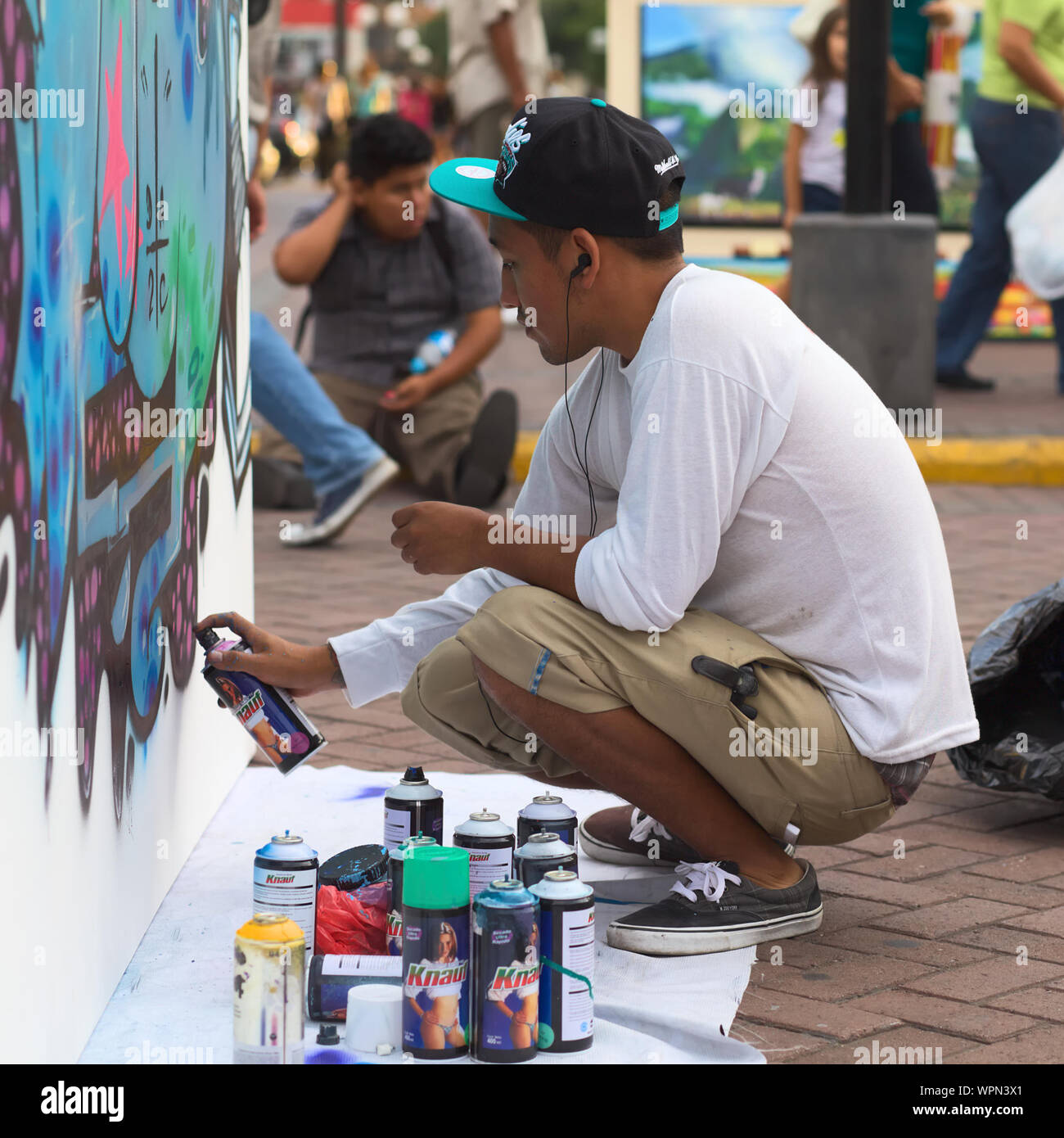 LIMA, PERU - MARCH 3, 2012: Unidentified young man spraying a wall on a sprayer competition on March 3, 2012 in Miraflores, Lima, Peru Stock Photo