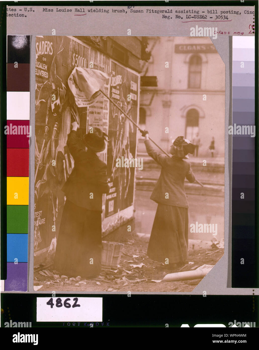 Louise Hall, with brush, and Susan Fitzgerald pasting billboard posters, Cincinnati, May 1912 Stock Photo