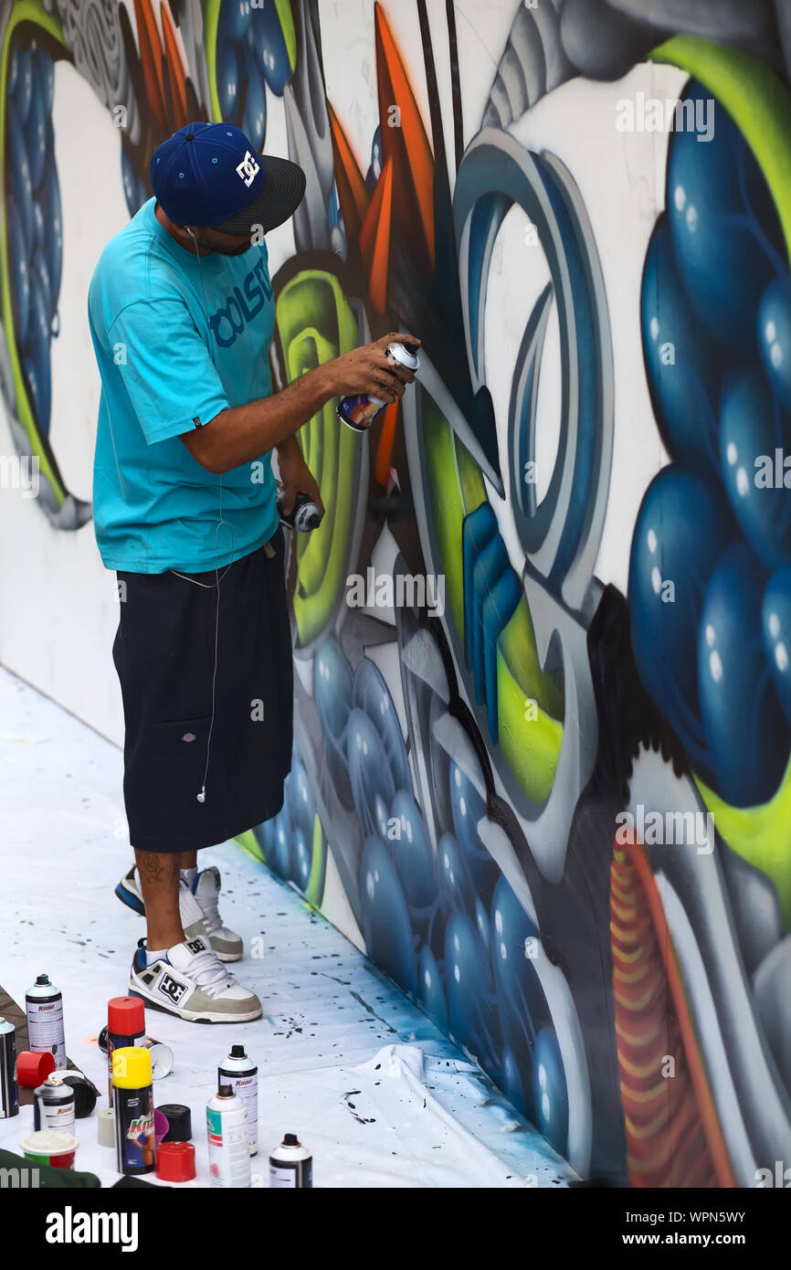 LIMA, PERU - MARCH 3, 2012: Unidentified young man spraying a wall on a sprayer competition on March 3, 2012 in Miraflores, Lima, Peru Stock Photo