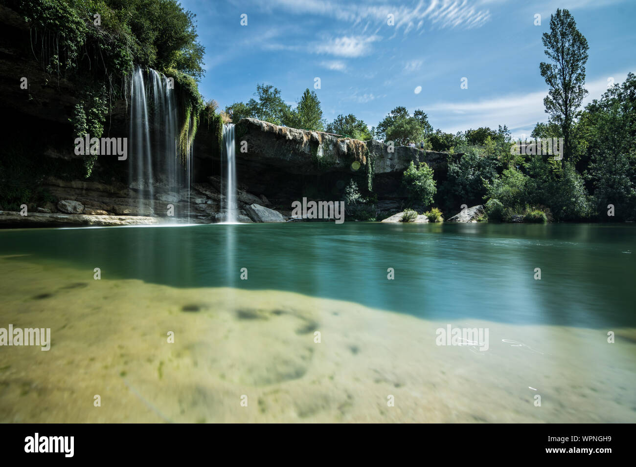 A beautiful waterfall in the middle of the forest Stock Photo - Alamy
