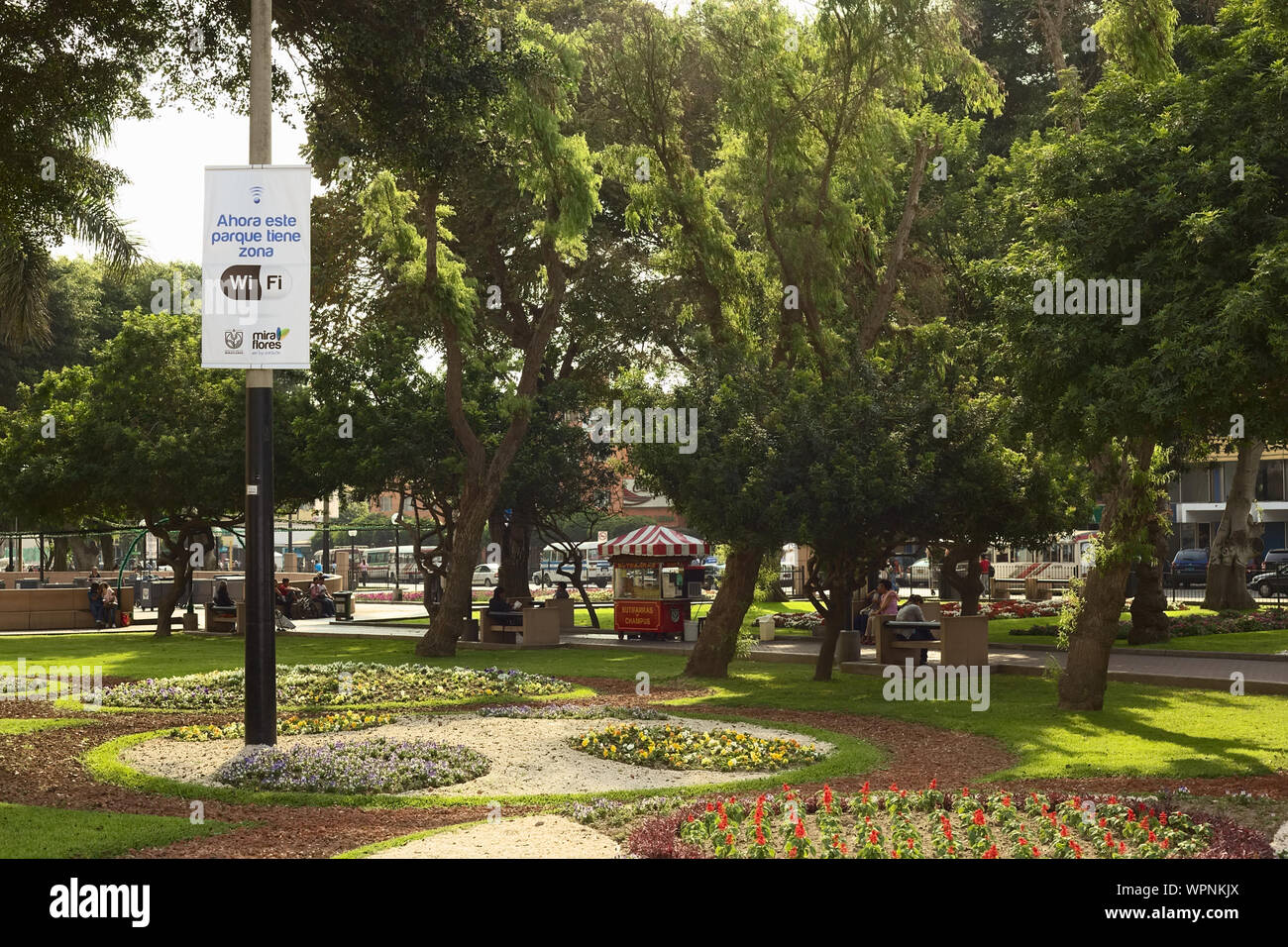 LIMA, PERU - DECEMBER 13, 2011: Wifi-Zone sign with unidentified people in the back in the Kennedy Park in the district of Miraflores, Lima, Peru Stock Photo