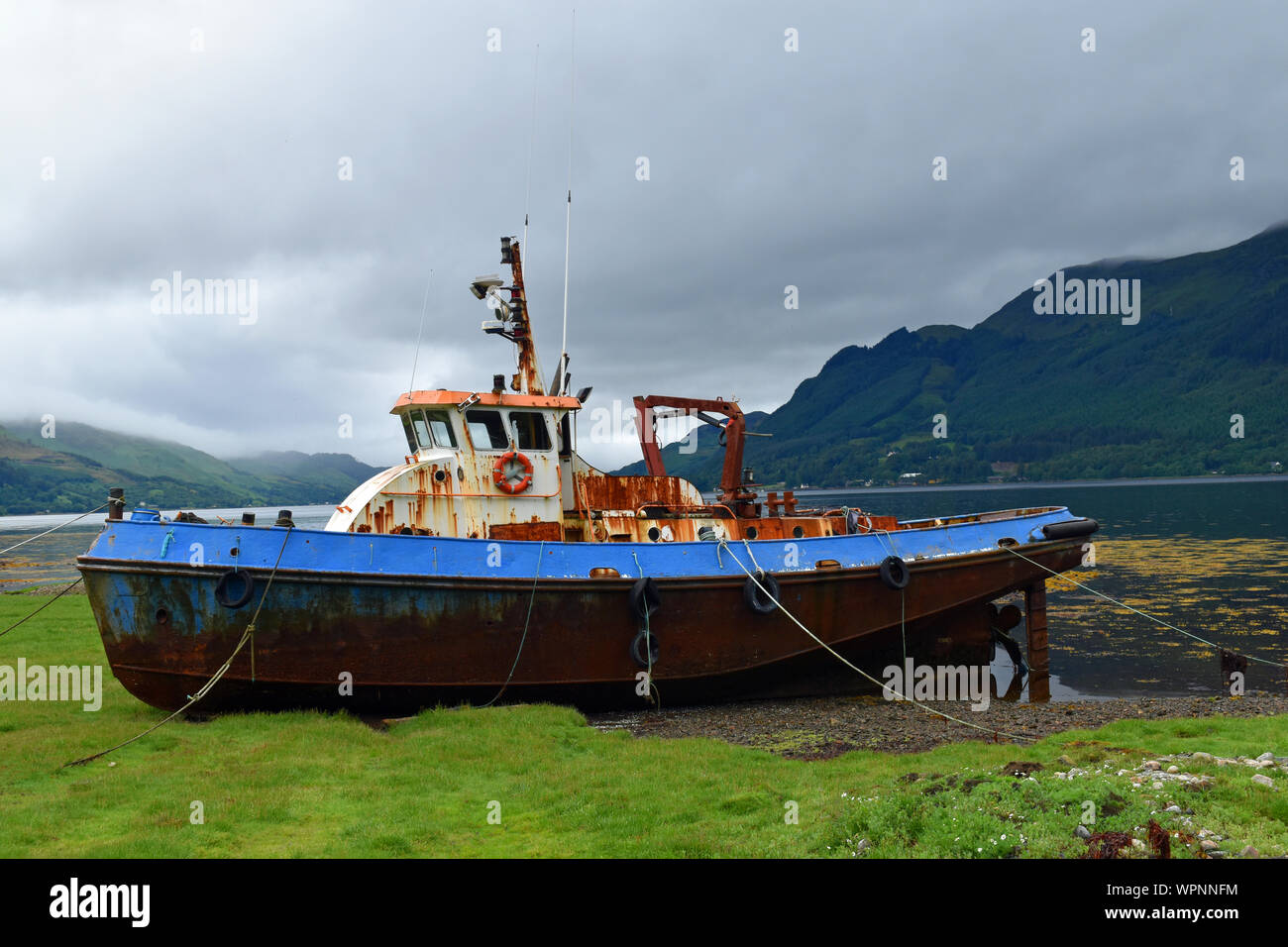 Rusting boat at the side of Loch Duich in Scottish Highlands Stock Photo