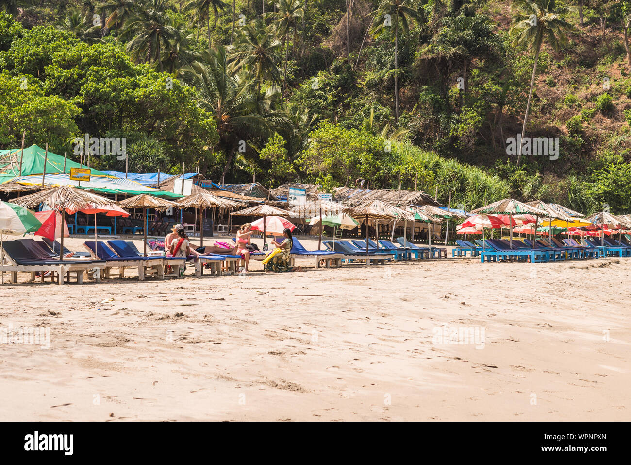 Ozran or Little Vagator Beach, Goa/India- April 21 2018: Tourists and families enjoying at Little Vagator or Ozran Beach in Goa India Stock Photo