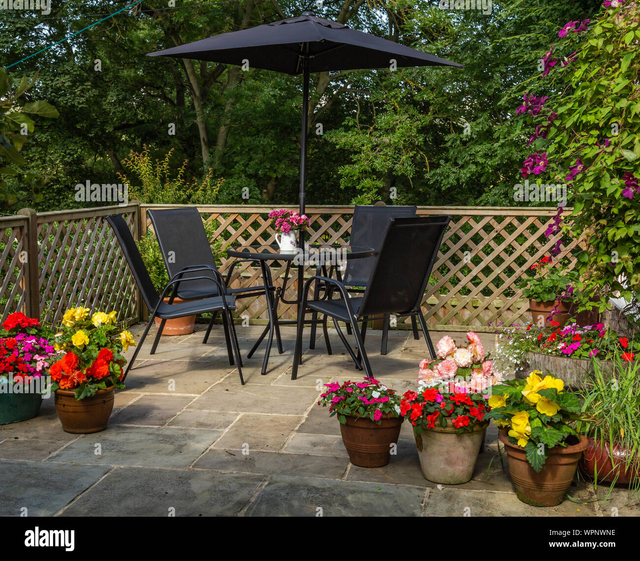 An English garden patio in summer. Stock Photo