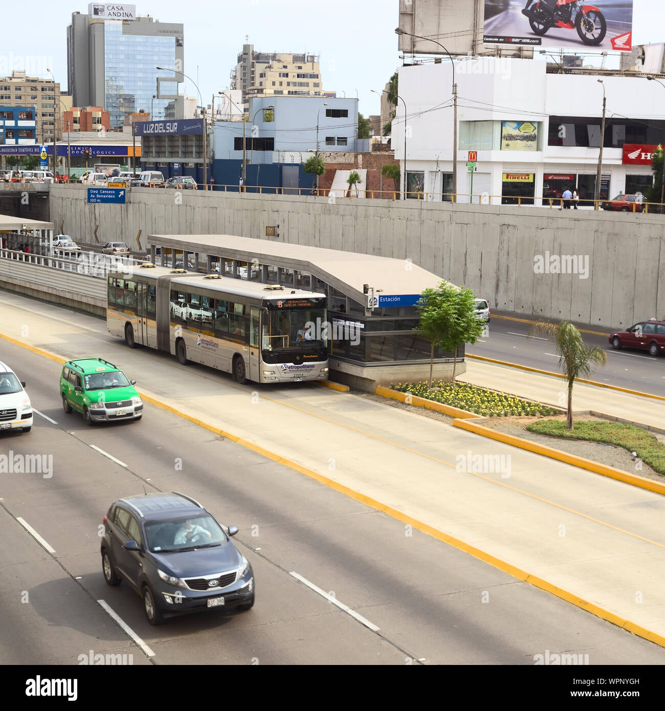LIMA, PERU - FEBRUARY 13, 2012: Metropolitano bus of the Line B stopping at the crossing of the Avenues Ricardo Palma and Paseo de la Republica Stock Photo