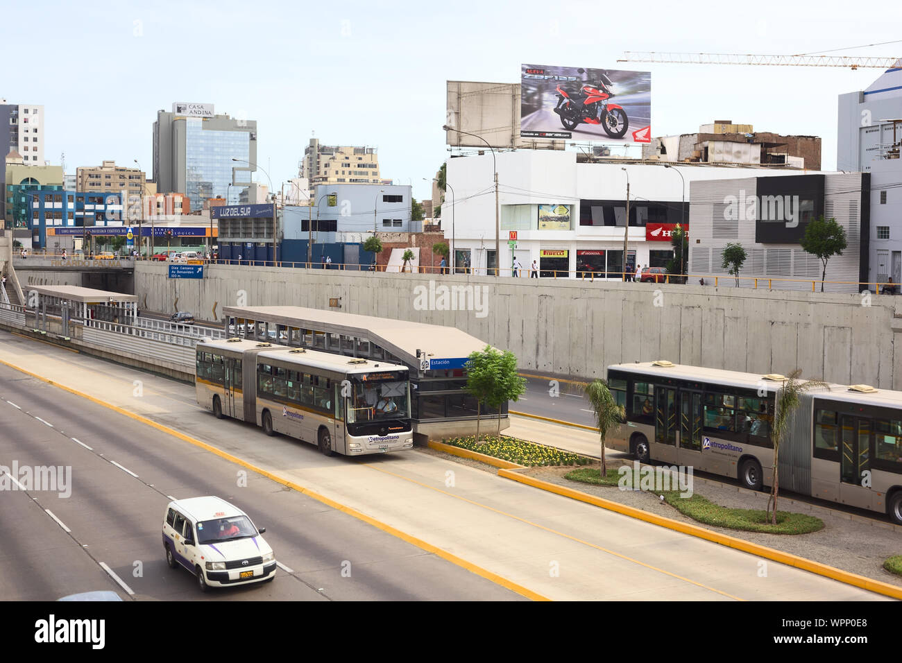 LIMA, PERU - FEBRUARY 13, 2012: Metropolitano bus of the Line A stopping at the crossing of the Avenues Ricardo Palma and Paseo de la Republica Stock Photo