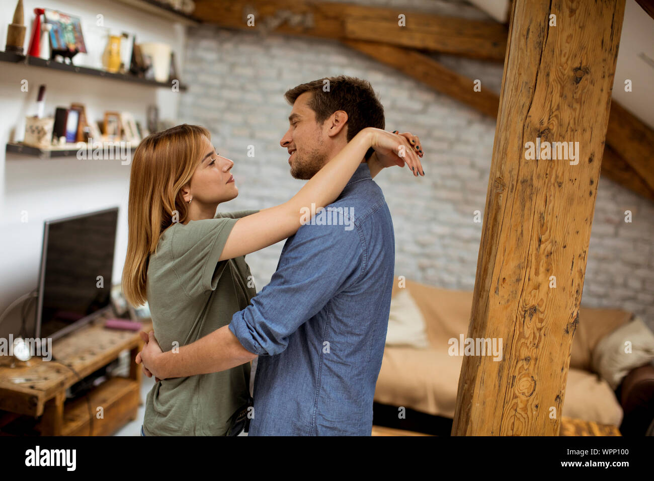 Young couple hugging in hi-res stock photography and images - Alamy
