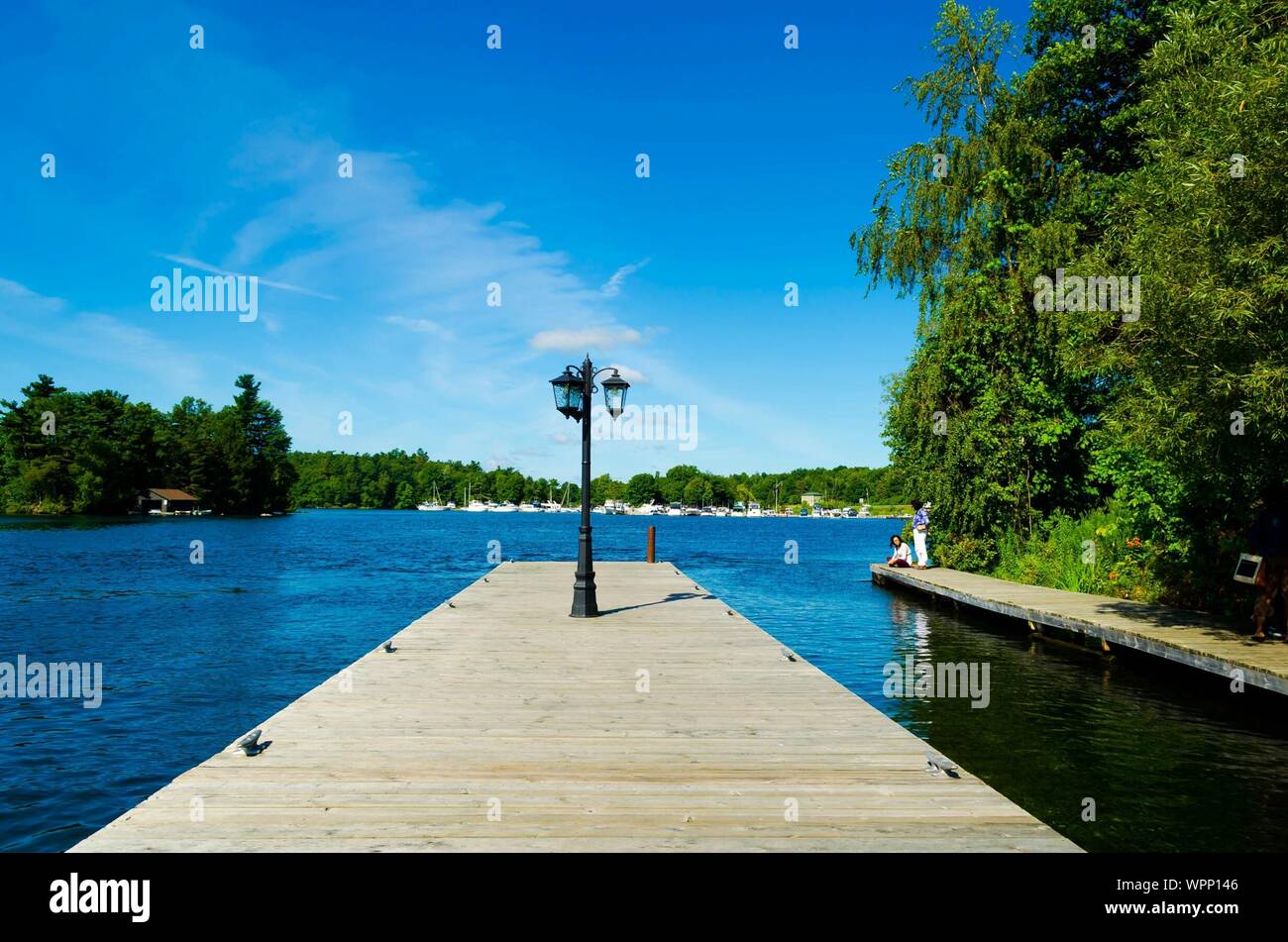 Street Light On Pier On Ontario Lake Against Sky At Thousand Islands National Park Stock Photo
