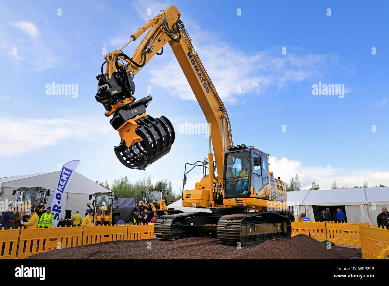 Hyvinkää, Finland. September 6, 2019. Komatsu HB 215 LC Hybrid excavator operator shows great precision by picking pack of cards with the grapple. Stock Photo