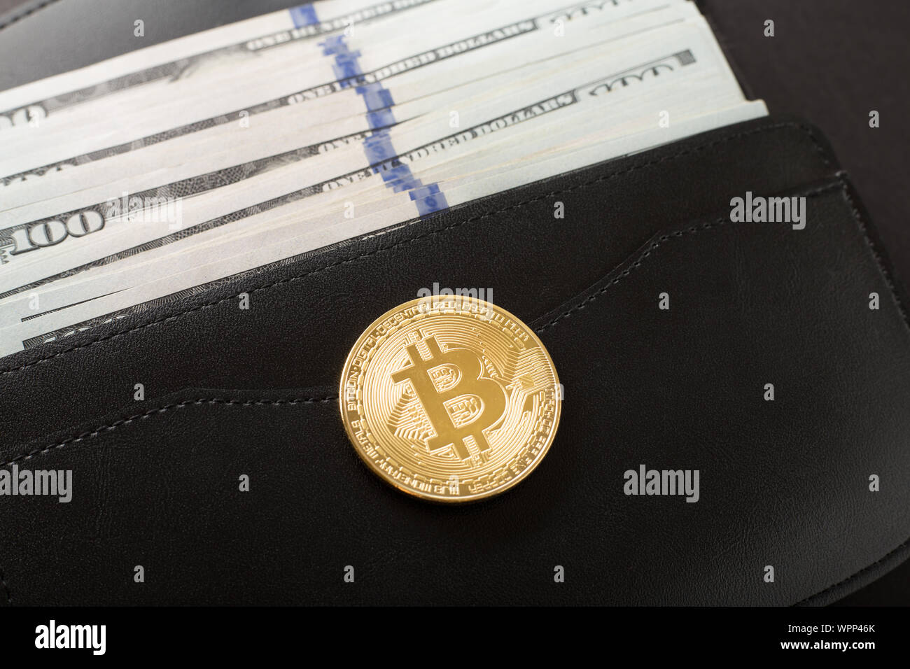 Bitcoin, hundred dollar bills and leather wallet on the orange background  Stock Photo - Alamy