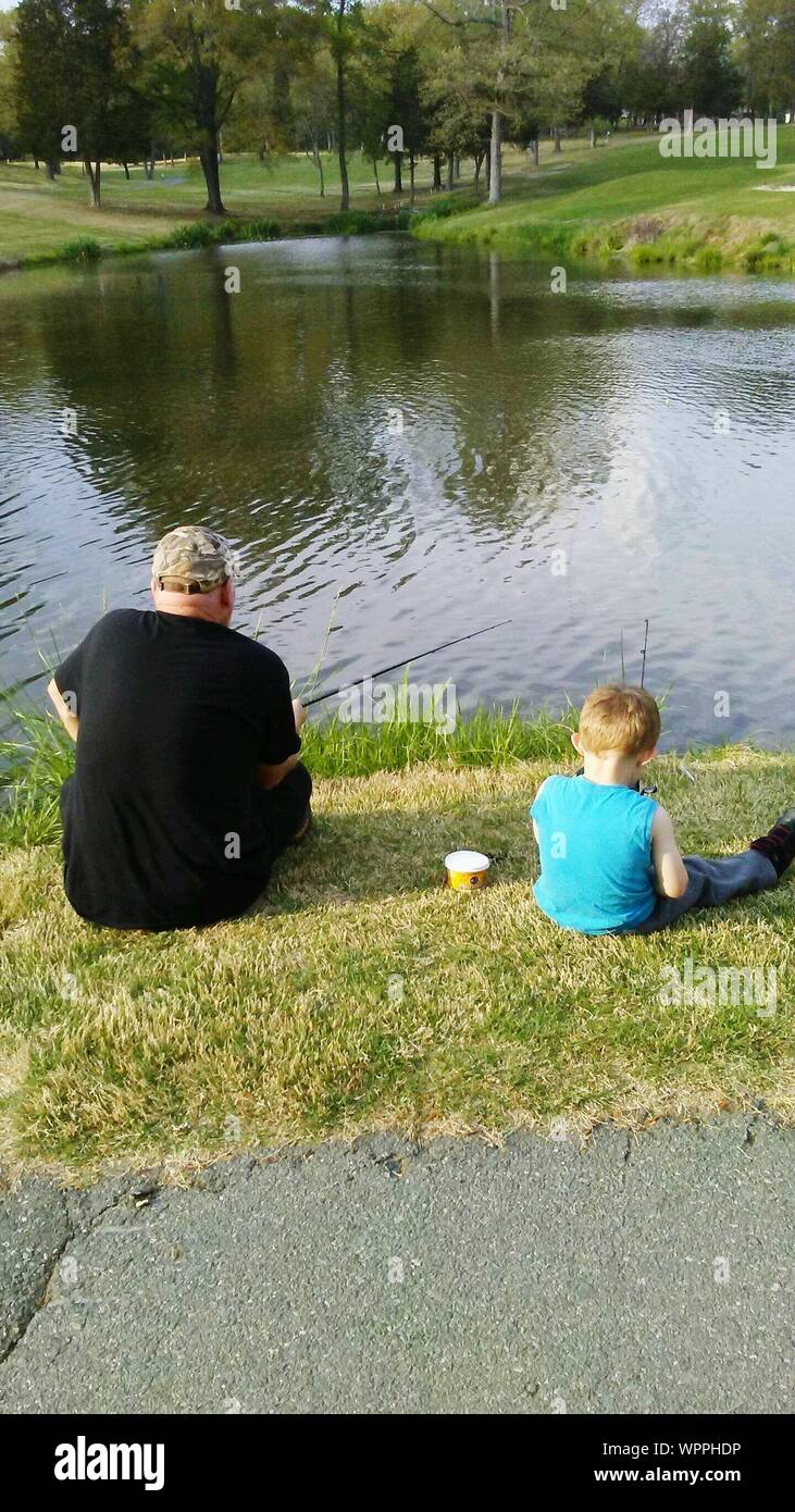 Two boys sitting fishing hi-res stock photography and images - Alamy