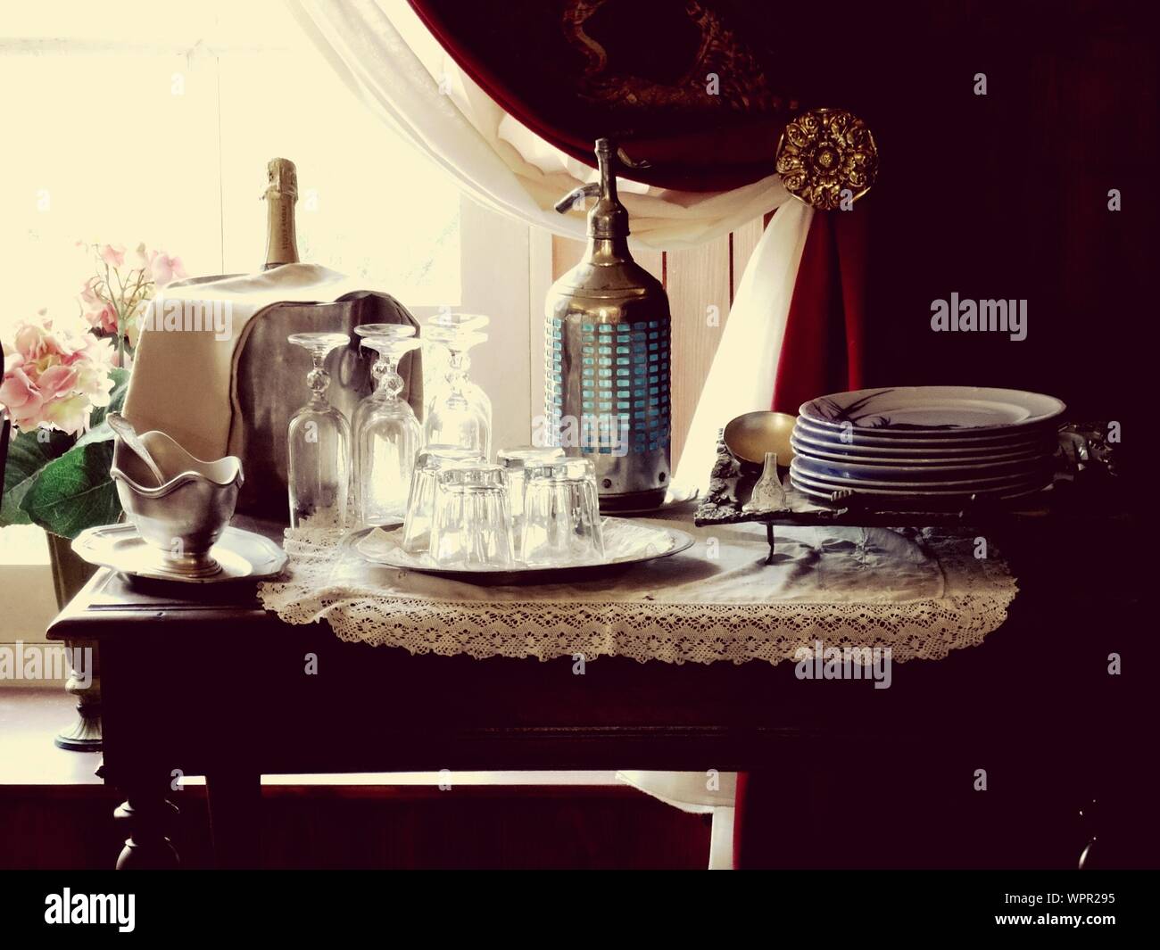 Plates And Glasses On Table At Home Stock Photo