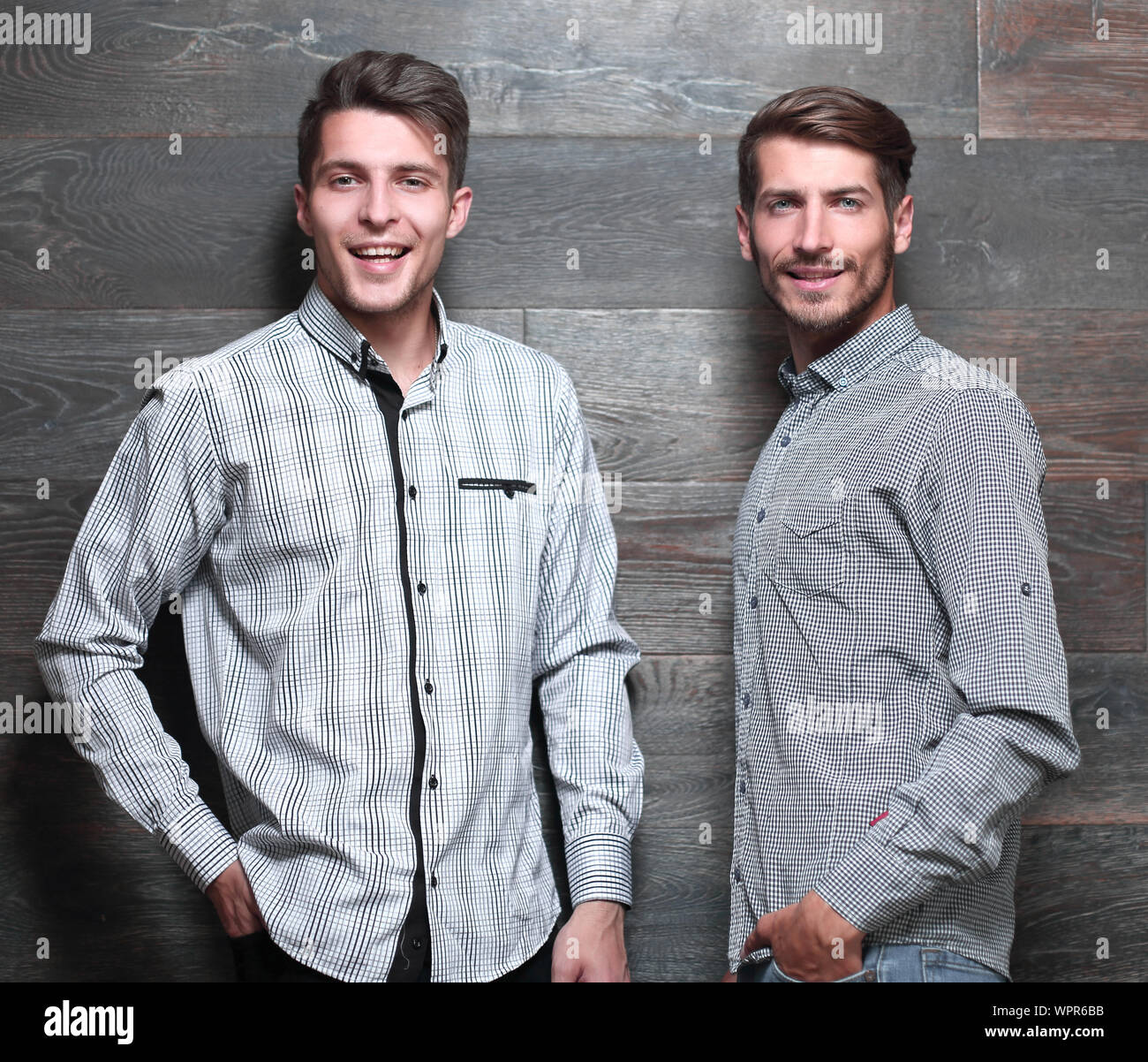 Two males in shirts isolated on a grey bachground Stock Photo - Alamy