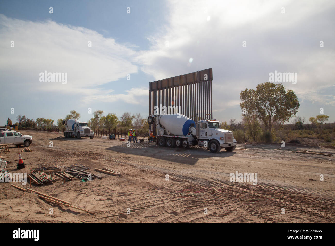 A U.S. Army Corps of Engineers Task Force Barrier contractor installs the first 5 barrier panels at the Yuma project site, near Yuma, Ariz., Sept. 5, 2019. The barrier system project spans approximately five miles, replacing existing barriers with steel bollard barriers. USACE is providing direction and oversight of Department of Defense (DoD)-funded construction of barrier system projects along the southwest border. These projects are being executed by USACE, as directed through the U.S. Army by the Secretary of Defense, in response to Department of Homeland Security’s request for assistance Stock Photo