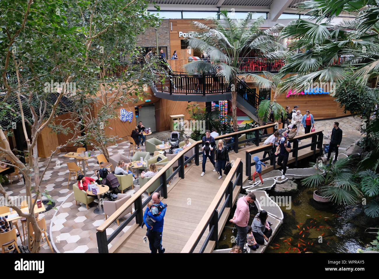 September 2019. Families at the main square area of The Plaza shopping center at Center Parcs Longleat Forest, Wiltshire, UK Stock Photo