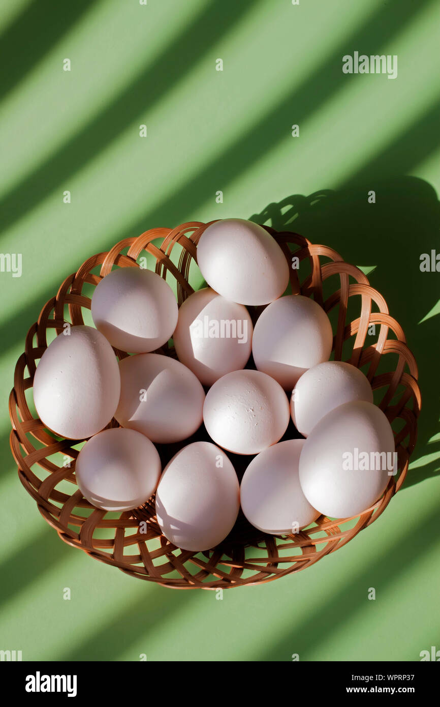 white eggs in basket vertical with copy space Stock Photo