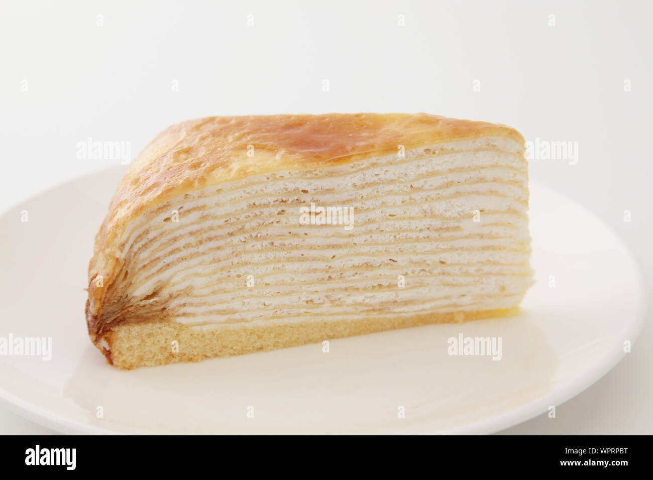Mille crepe french cake on a plate isolated on white background Stock