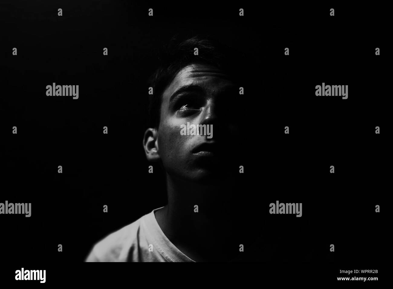 Portrait Of Teenage Boy Against Black Background Stock Photo Alamy