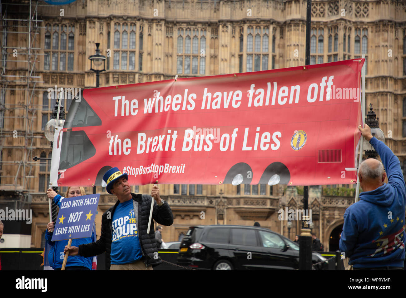London, UK. 9th September, 2019. Large banner of the anti-Brexit demonstration outside the Houses of Parliament, Westminster, showing a London bus saying ' the wheels have fallen off the Brexit Bus of lies'. The man with the blue hat is the well-known anti-Brexit activist Steve Bray or Mr Stop Brexit. Credit: Joe Kuis / Alamy News Stock Photo