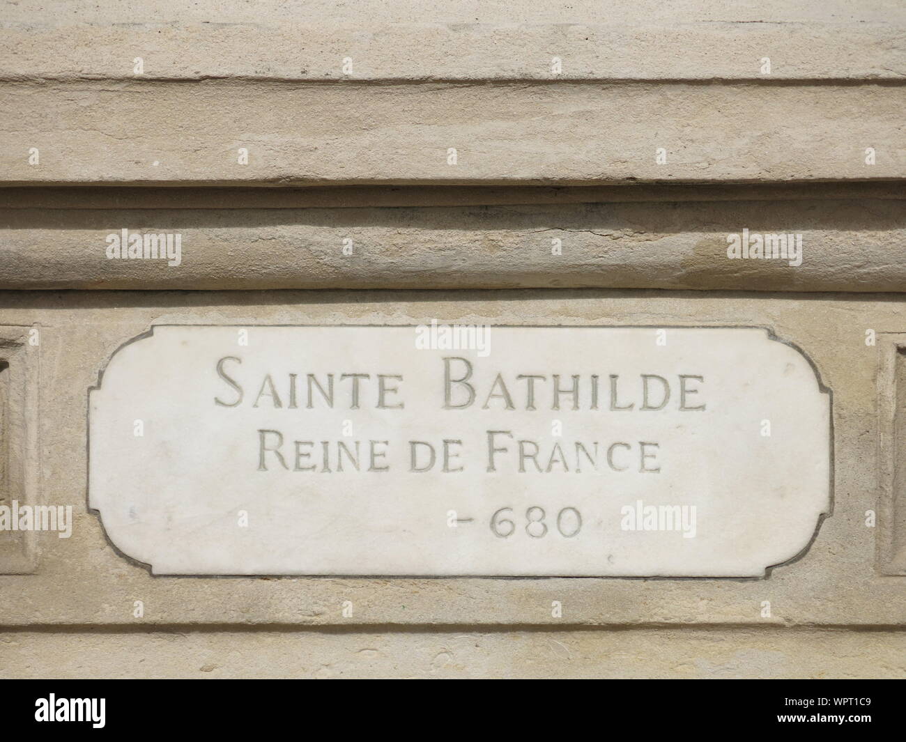The engraving at the foot of the stone pedestal for the sculpture of 'Sainte Bathilde Reine de France', a 7th century Queen in French history. Stock Photo