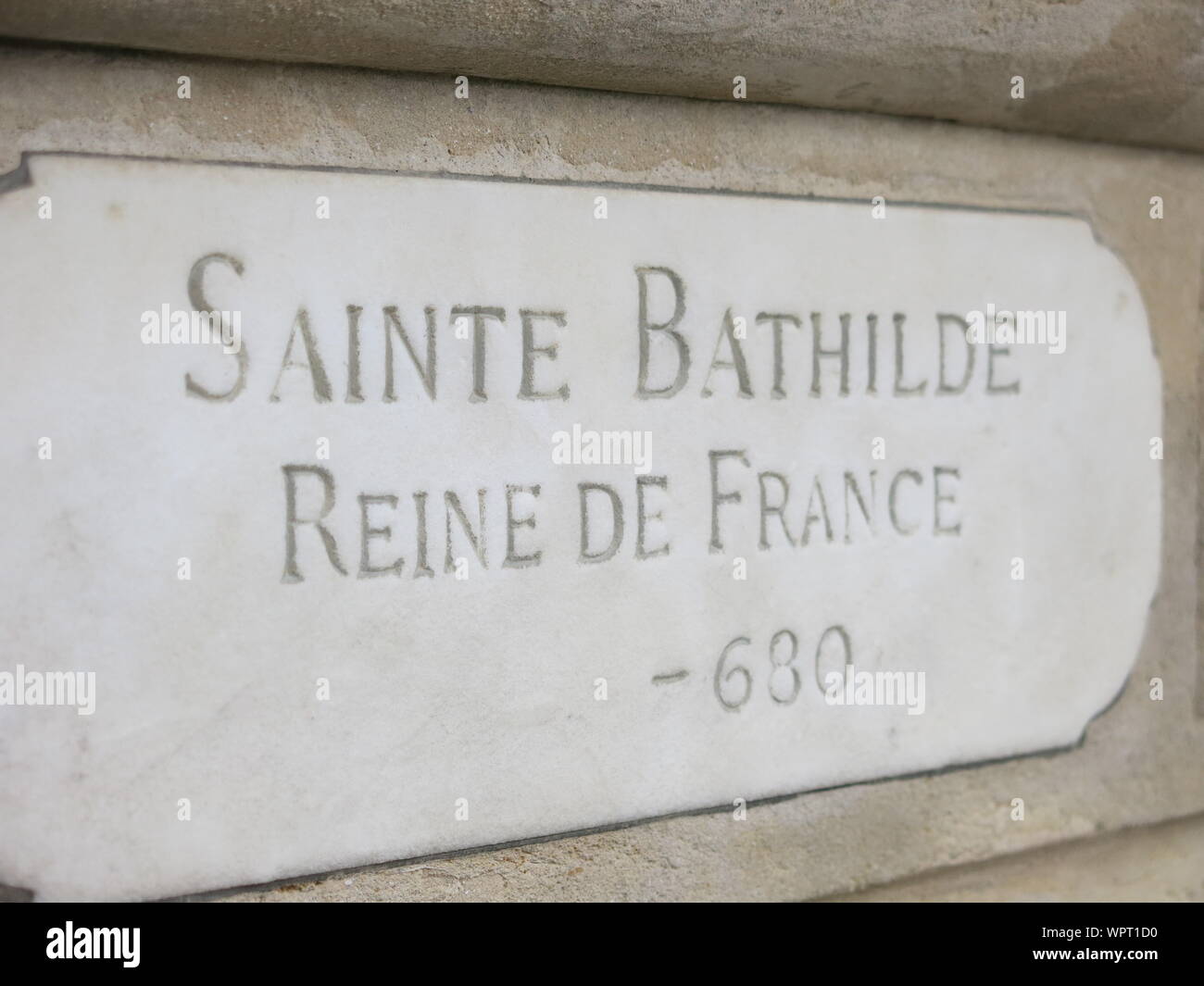 The engraving at the foot of the stone pedestal for the sculpture of 'Sainte Bathilde Reine de France', a 7th century Queen in French history. Stock Photo