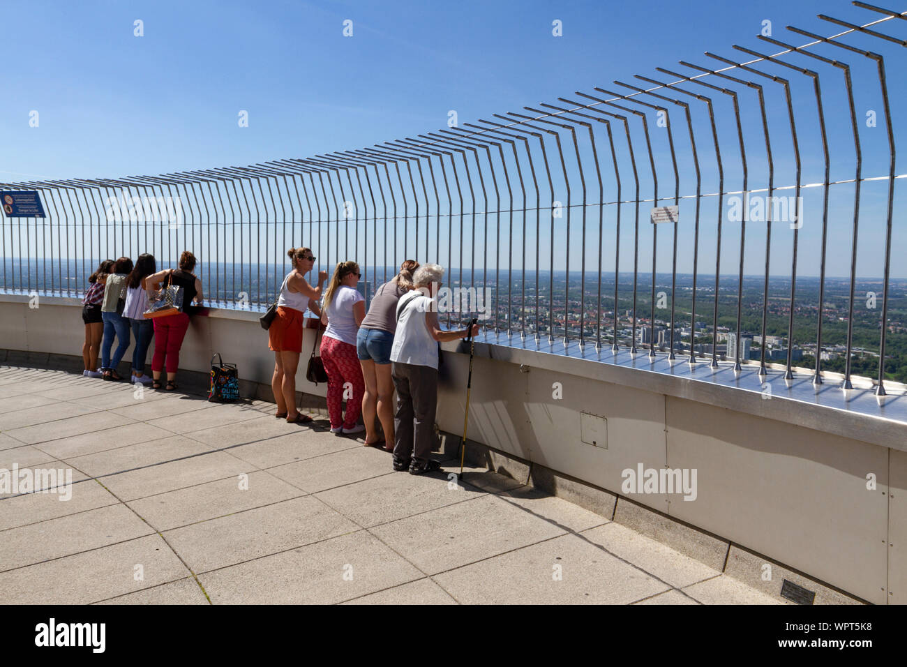Visitors on the viewing platform of the Olympiaturm, (Olympic Tower), part of the Munich 1972 Olympic Park, Munich, Bavaria, Germany. Stock Photo