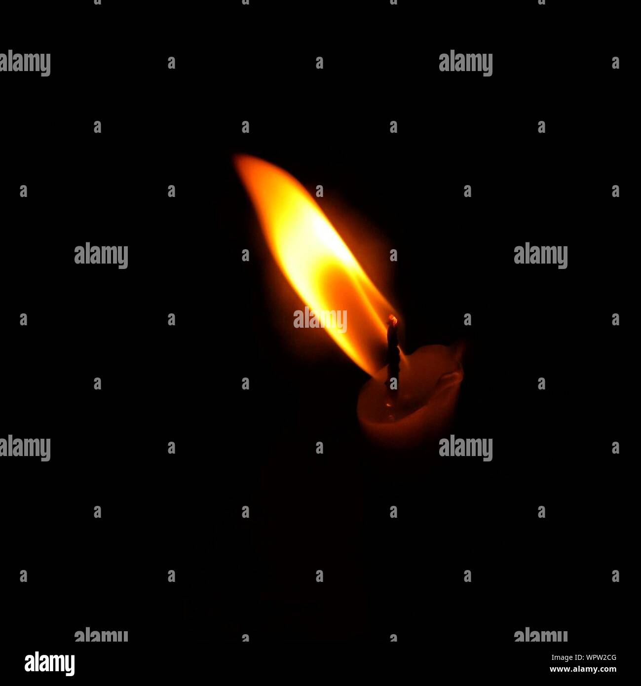 Lit candle in the dark room hires stock photography and images Alamy