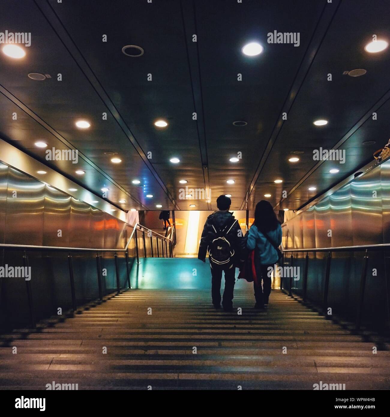 High Angle View Of People Walking On Steps Against Illuminated