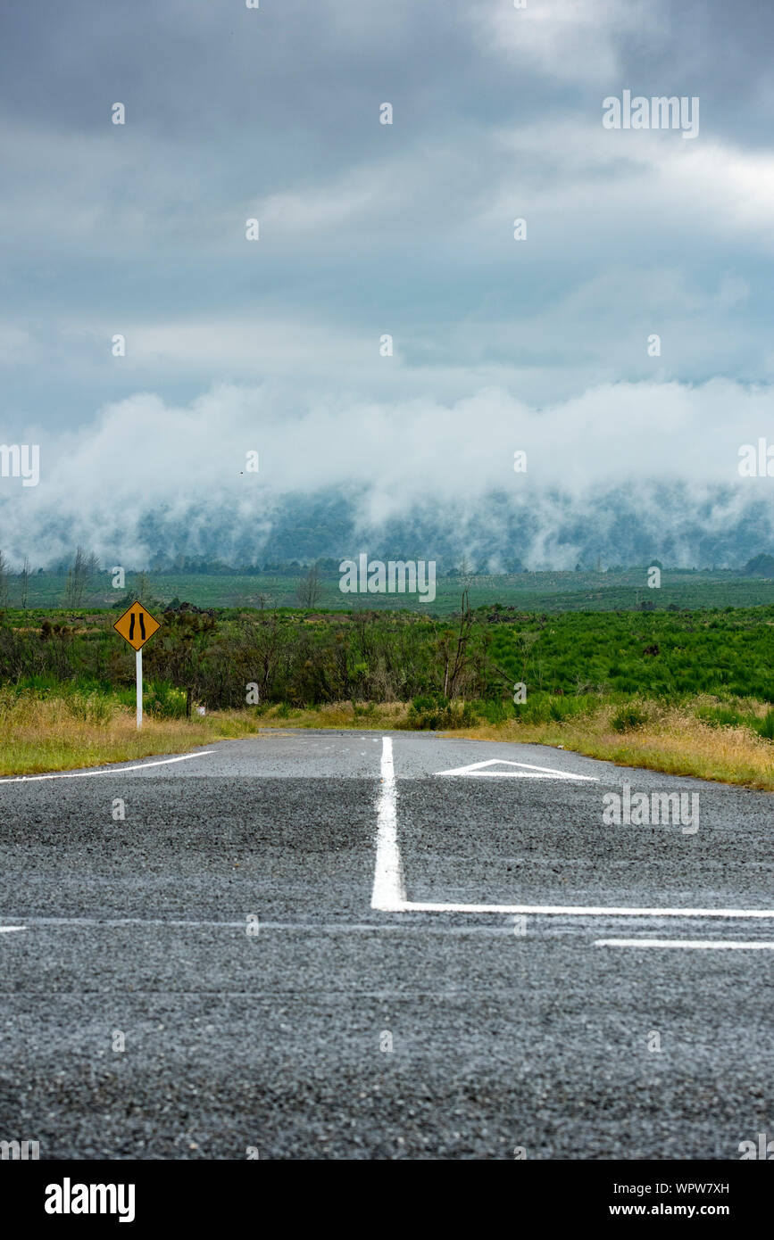 Give Way intersection. Geo thermal landscape where steam is eminating from the ground. Central North Island of New Zealand Stock Photo