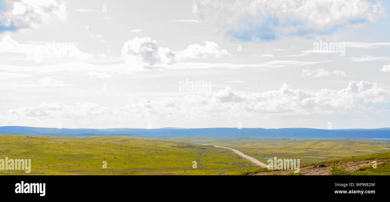 Silver sky over the tundra road. Murmansk land is a beautiful and entrancing. Roads go into the clouds through the hills Stock Photo
