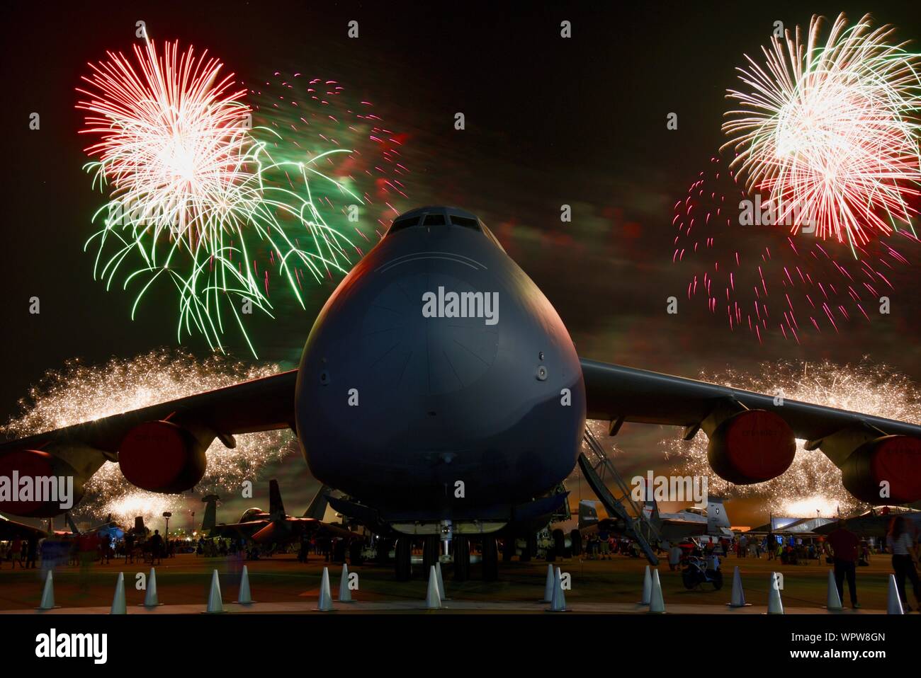 Spectacular fireworks explode behind massive Lockheed C-5M Super Galaxy ...
