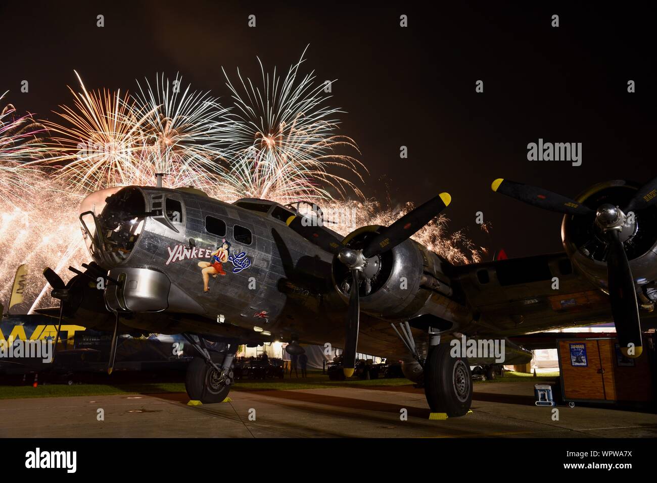 Spectacular fireworks explode behind 'Yankee Lady' B-17 World War 2 bomber aircraft parked in Boeing Plaza of EAA AirVenture, Oshkosh, Wisconsin, USA Stock Photo