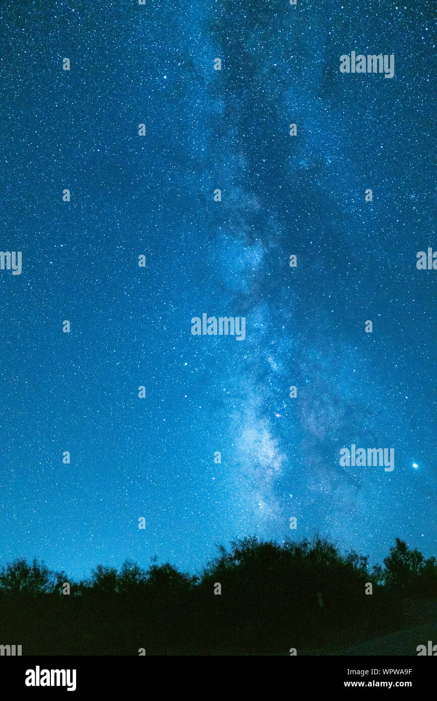 A vertical composition of the sky and stars of the milky way Stock Photo