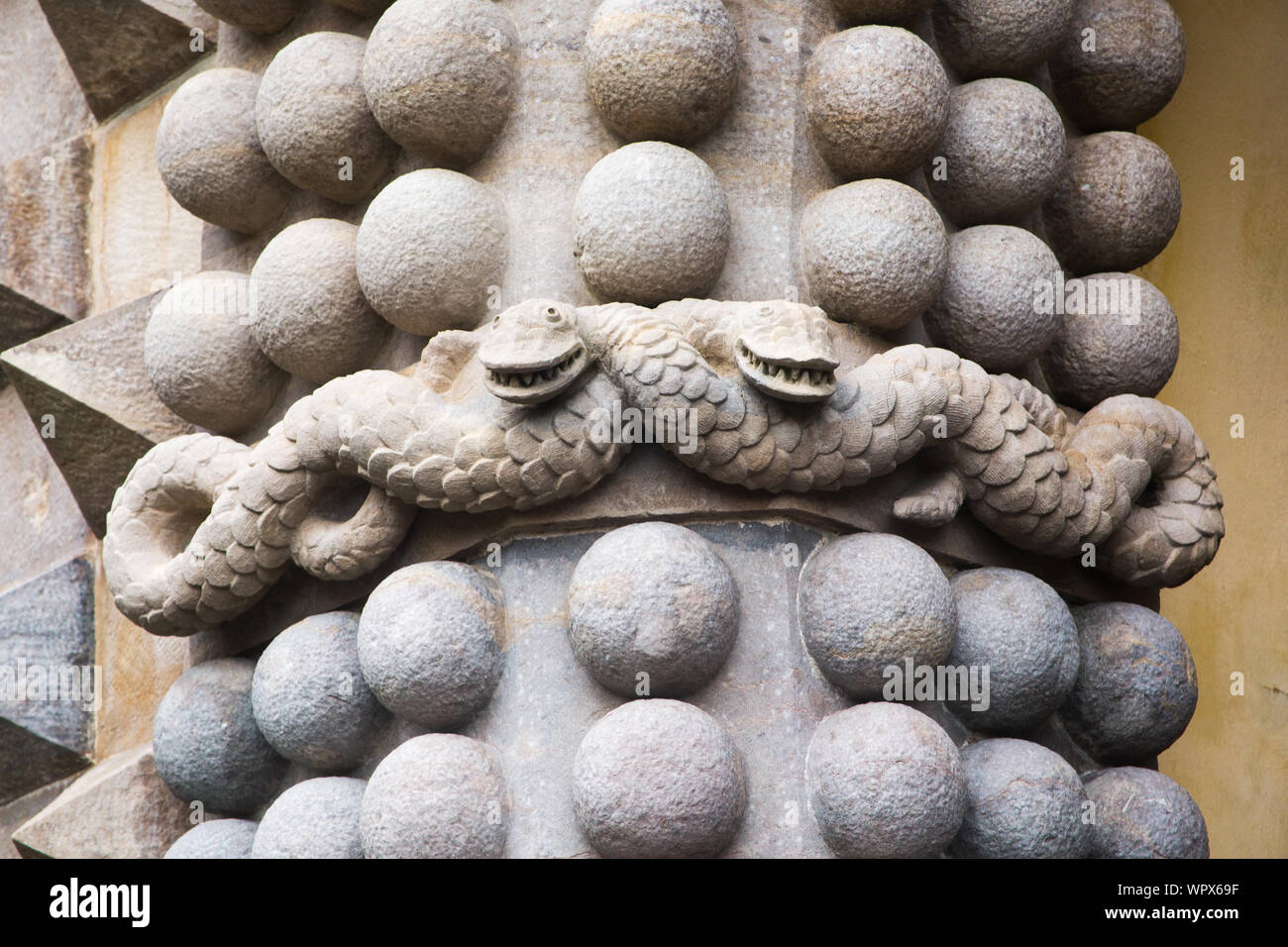 Decorative stone snakes and ball pattern on wall at the 19th century romanticist hilltop Castle of Pena Palace (Palácio da Pena), Sintra, Portugal. Stock Photo