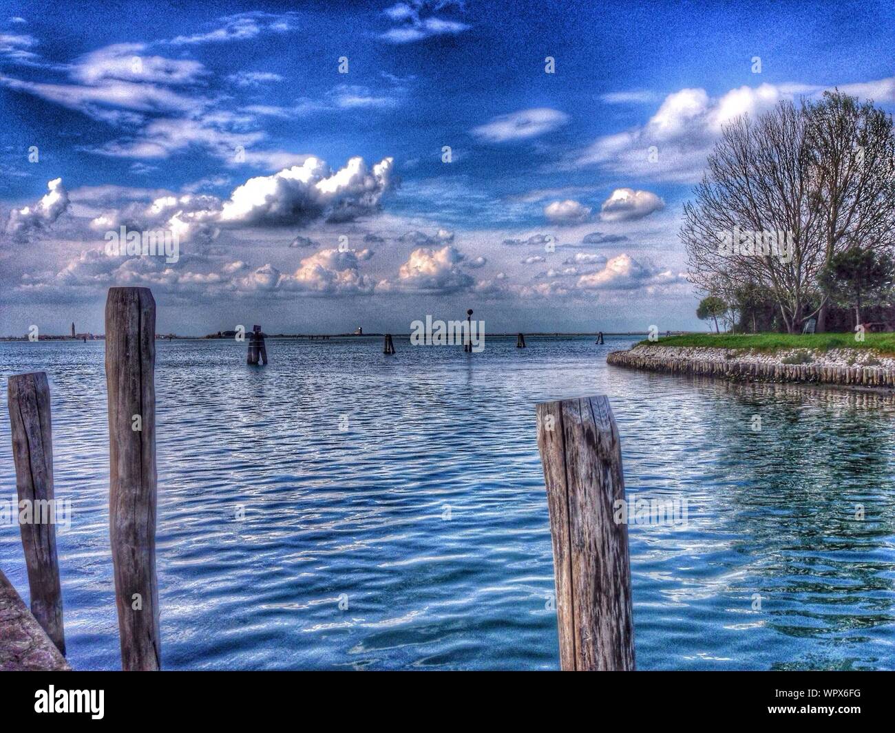 Wooden Poles In Calm Blue Sea Stock Photo - Alamy