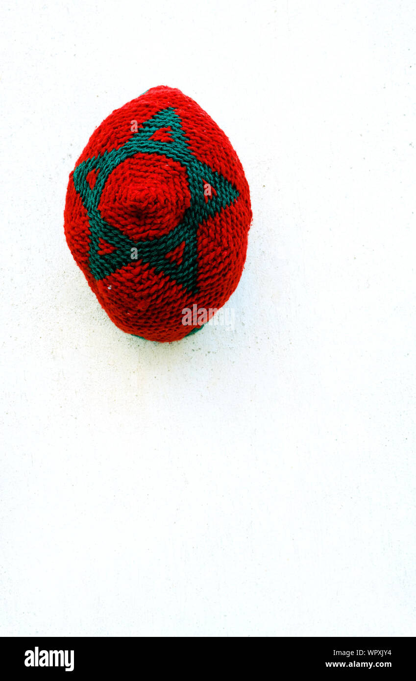 Directly Above Shot Of Star Shape On Woolen Ball Against White Background Stock Photo