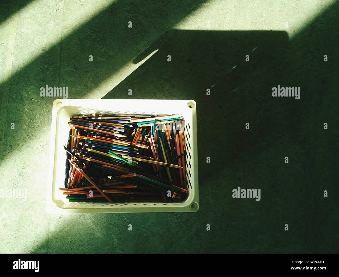 High Angle View Of Pencils In Container On Table Stock Photo