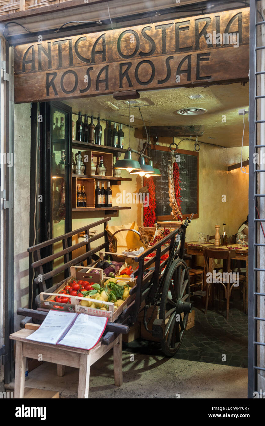Small colorful restaurant featuring local produce on wheeled cart, Antica osteria rosa rosae, Via di Pietra, 70, 00186 Roma RM, Italy Stock Photo