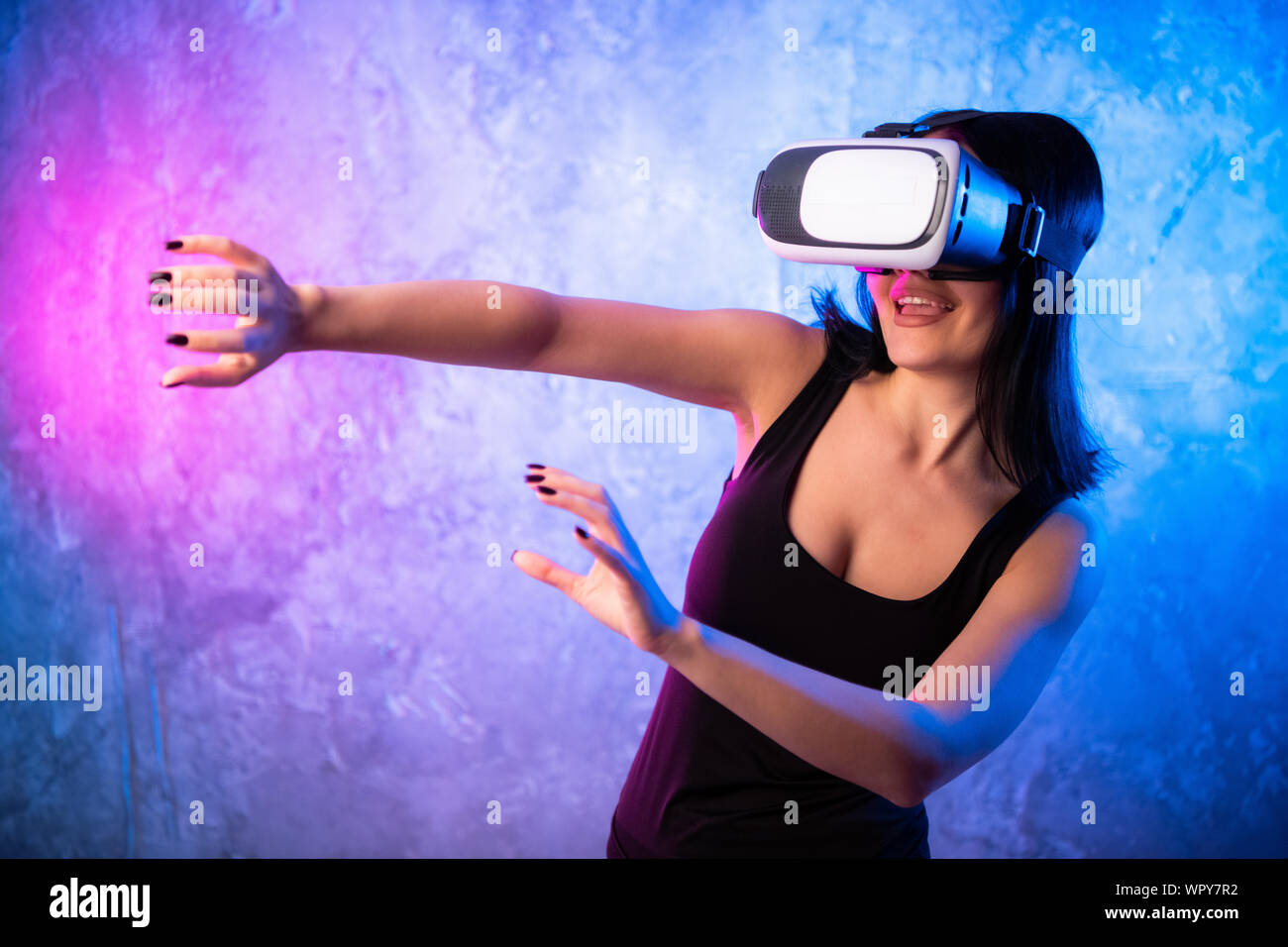 Young teen gamer wearing VR glasses standing and playing virtual reality  game Stock Photo - Alamy