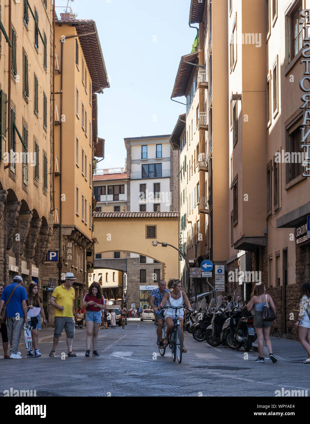 Street Scene with pedestrians, bicycles, cars and motorcycles, Piazza de Pitti, Florence, Italy Stock Photo