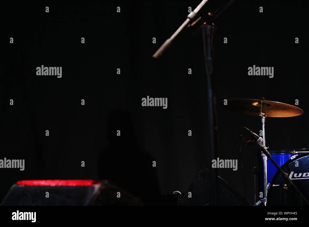Microphone Stand On Illuminated Stage Stock Photo