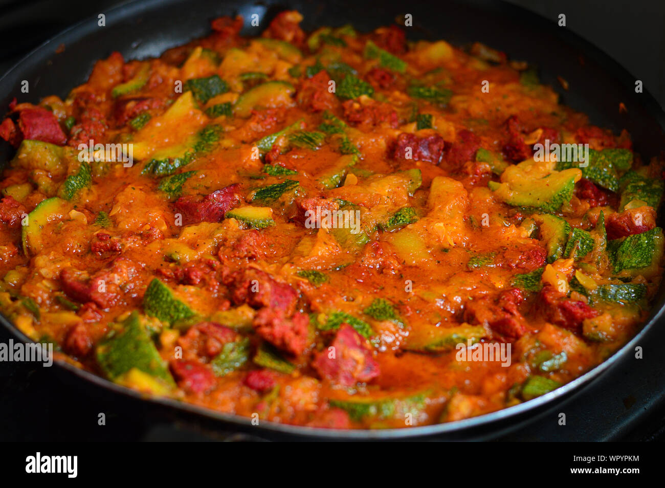 Vegetarian chorizo with courgette in tomato sauce Stock Photo