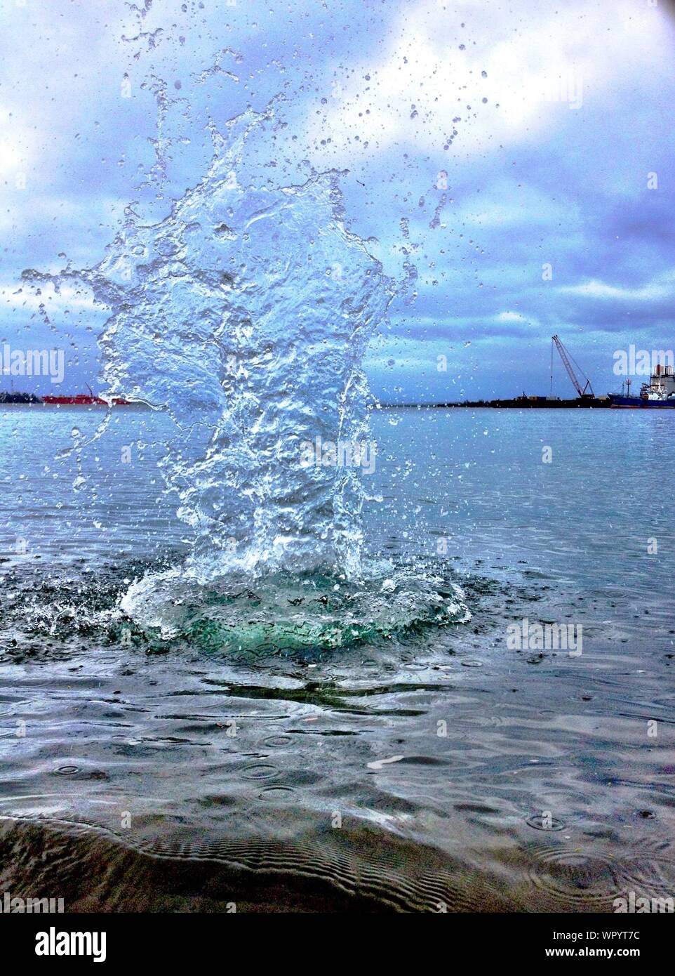 Splash Created By Stone Hitting Water Stock Photo