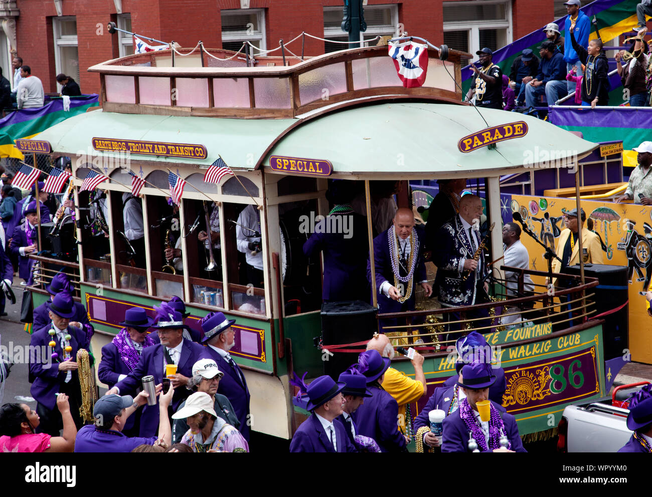 Mardi Gras Parade, New Orleans, Louisiana.   Mardi Gras Day 2011 in New Orleans. Pete Fountain's Half-Fast Marching Club Parade.  Band float in shape of a streetcar; Pete Fountain is at front right. Stock Photo