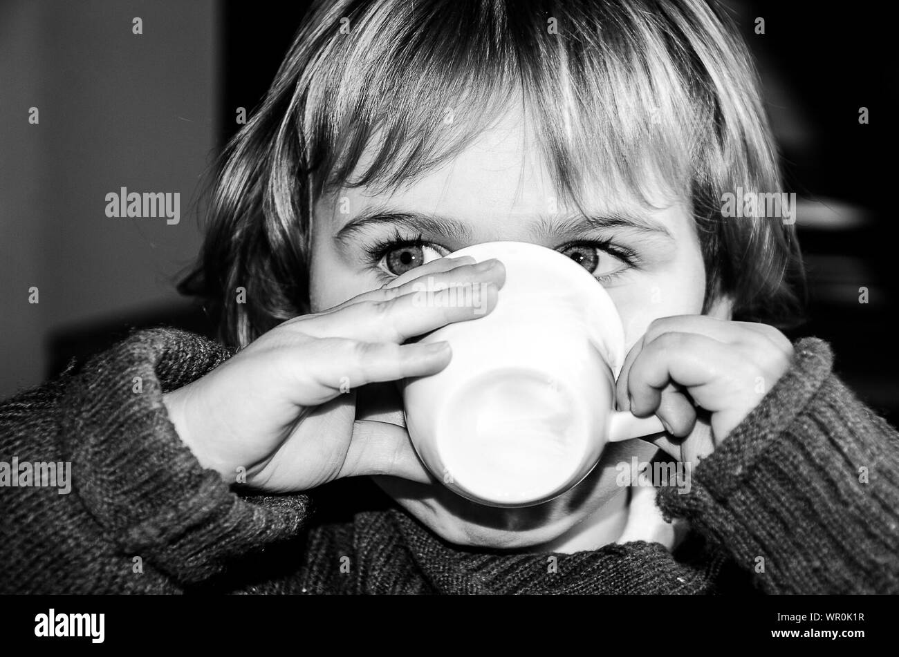 Close-up Of Girl Drinking At Home Stock Photo