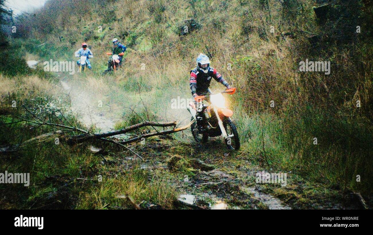 Motocross Racer On Move Through Forest Stock Photo