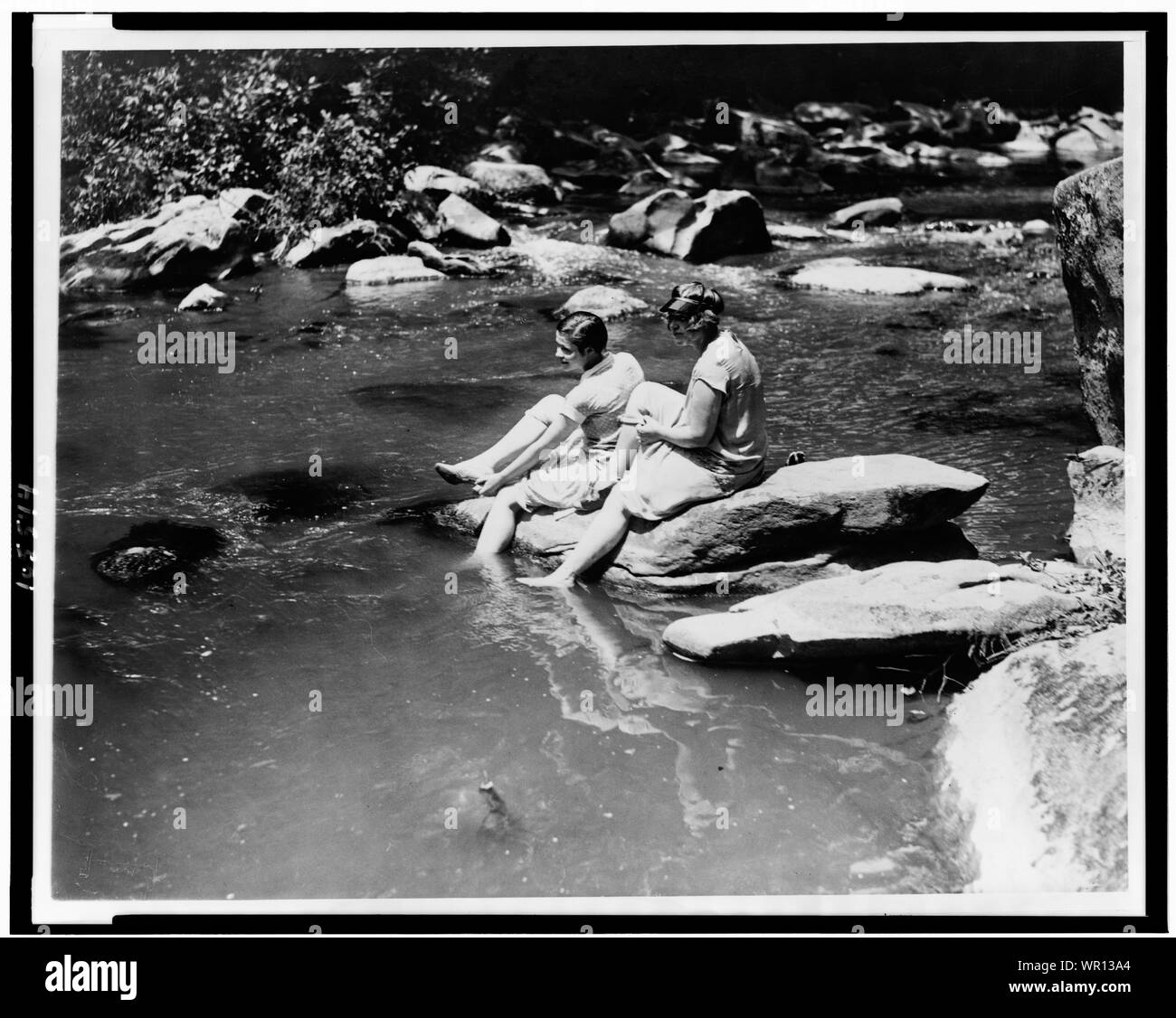 Marion Newton and Ruth Williams preparing to wade in Rock Creek, after suffering with the intense heat of the past two days, when the thermometer recorded 104 degrees Stock Photo